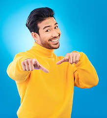 Image showing Man, studio portrait and point at you with smile, choice and recruitment with fashion by blue background. Young Indian guy, gen z student and finger for decision, hiring and opportunity with clothes