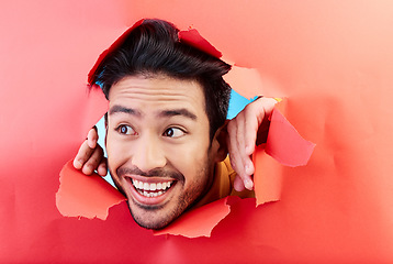 Image showing Man, studio and face breakthrough paper with smile, excited and thinking with opportunity, vision and ideas. Young Indian guy, student or model with looking ahead, mindset and happy for future life