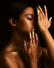 Image showing Woman, gold makeup and studio for paint, beauty or body art for creativity, design and black background. Girl, model and skin with metallic texture, pattern or color for cosmetics with dark aesthetic