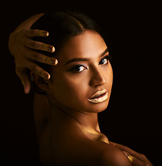 Image showing Woman, gold makeup and studio portrait with paint, beauty or body art for creativity, design or black background. Girl, model or skin with metal texture, pattern or color with cosmetic for aesthetic