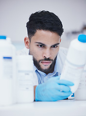 Image showing Laboratory, man or scientist reading container to check medical stock or information on cure. Research study, bottle label data or science researcher in manufacturing job with chemical inventory