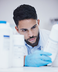 Image showing Laboratory, man or scientist reading bottle to check medical stock or info on cure breakthrough. Research study, container label or science researcher in manufacturing job with chemical inventory