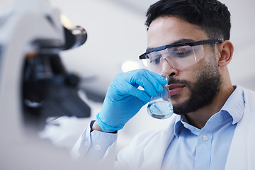 Image showing Man, smell or scientist with liquid to research for a test analysis, experiment or medical innovation. Beaker, studying biotechnology or researcher sniffing in laboratory for science development