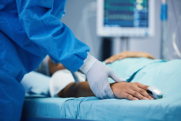 Image showing Holding hands, healthcare and a doctor with a patient in surgery for pulse, help or support. Hospital, medicine and closeup of a surgeon in theater with a person for consultation or medical nursing