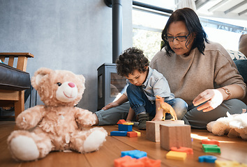 Image showing Toys, family or kids with a mother and son playing in the bedroom of their home together for child development. Children, teddy bear or education and a boy learning motor skills with a woman parent