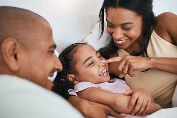 Image showing Family, happiness and father with mother and daughter, touching nose and relax in bed, playful and bonding. Carefree, love and fun with people in bedroom, happy and spending time together at home