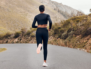 Image showing Fitness, running and back with black woman in nature for health, workout and challenge. Performance, sports and exercise with female runner training on mountain road for speed, marathon and wellness