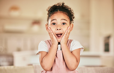 Image showing Wow portrait, reaction and a child in a house for news, announcement or excited. Shock, lounge and a young girl with a surprise expression a home living room for achievement or communication