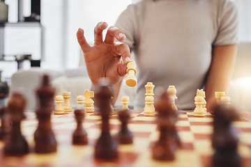 Image showing Chess, game and woman with board moving piece for strategy, thinking and challenge in home. Competition, problem solving and hands of female person with chessboard in living room playing to checkmate