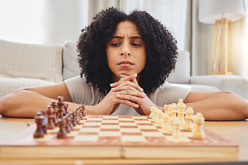 Image showing Thinking, strategy and face of woman with chess for problem solving, planning and challenge at home. Competition, contest and female person with chessboard in living room ready for playing games
