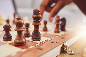 Image showing Chess, game and closeup of hand with board moving piece for strategy, thinking and challenge. Competition, winning and zoom of hands of person with chessboard in living room for playing to checkmate