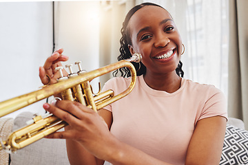 Image showing Music, portrait and woman in home with trumpet, smile and band practice for orchestra concert in living room. Art, creativity and jazz culture, happy African musician on sofa with musical instrument.