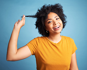 Image showing Happy, portrait and a young woman with curly hair in studio with a smile and cosmetics. Face of an african female person with afro hairstyle, natural beauty and confidence on a blue background