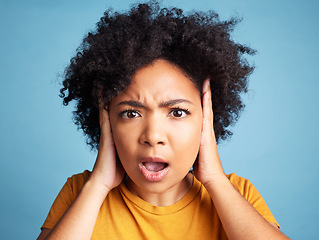 Image showing Surprise, wow and portrait of a woman with anxiety, bipolar or mental health problem. Shock, fear and face of a young girl with scared or panic expression and isolated on a blue background in studio