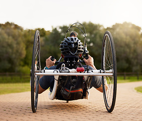 Image showing Disability, bicycle and paraplegic person cycling as morning exercise, workout or training for wellness and health. Handbike, sports and person on a wheelchair bike training strength and endurance