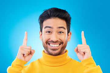 Image showing Pointing up, excited and portrait of Asian man on blue background for news, announcement and information. Advertising, marketing and face of male person with hand gesture for promotion, deal and sale