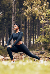 Image showing Stretching, fitness and black woman lunge in nature for exercise, training and sports in forest. Hiking, mountain and female person stretch legs for warm up, workout and wellness for performance