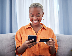 Image showing Home, phone or happy black woman with credit card or phone on payment on internet website or fintech. Online shopping, finance or excited African girl typing in money transfer via mobile banking