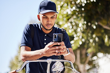 Image showing Bicycle, phone and delivery man use phone typing location to navigate a street of a city for a package, product or fast food. Bike, GPS and courier employee use map online, internet or ecommerce web