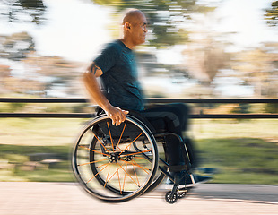 Image showing Man with a disability, wheelchair and motion of exercise in the park, nature or athlete in outdoor fitness training. Blurred background, sport and disabled person exercising or speed on wheels