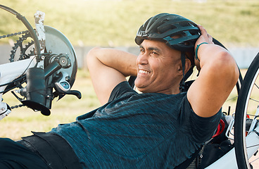 Image showing Cycling, fitness and man with disability training for competition with smile, motivation and exercise on bike. Happiness, workout and person on recumbent bicycle for outdoor race track for challenge.