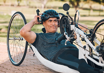 Image showing Sports, athlete or a man with a disability and bike for handicap race, fitness and recumbent challenge. Exercise, happy and a handbike of Paralympic person outdoor for cycling or cardio for training