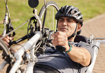 Image showing Man with disability, handbike and cycling outdoor for sports, race and endurance contest. Bicycle, male rider and athlete with physical health condition on bike with focus, competition and challenge