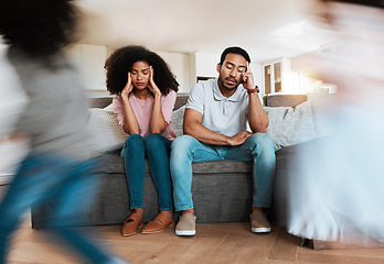 Image showing Kids running with stressed parents on the sofa to relax in the living room of their house. Upset, burnout and excited children playing with blur motion on couch with tired exhausted mother and father