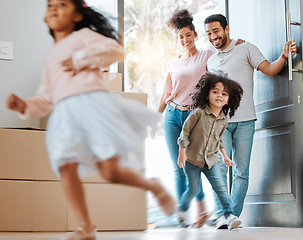 Image showing Happy, moving and parents with children running in their new modern family house with excitement. Happiness, smile and young mother and father watching their kids jumping in blur motion at their home