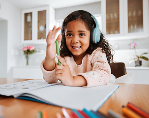 Image showing Girl child, home and drawing with headphones, notebook or smile for homework, learning or study at desk. Kid, music and education with audio streaming, book or pen for writing, notes or happy in home