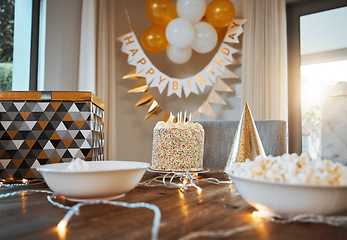 Image showing Birthday, party and cake on table with decoration in living room for event, celebration and social gathering. Food, surprise and closeup of dessert, snacks and sweet treats with presents at home