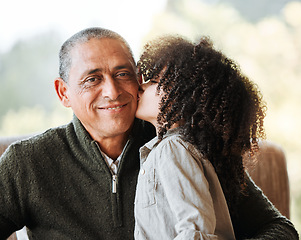 Image showing Grandfather, kid and kiss cheek in home living room, smile or portrait for love, care and bonding. Senior man, young child and happy with quality time, retirement and relax with hug in family house