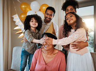 Image showing Birthday, surprise and children with grandmother at party in living room for event, celebration and social gathering. Family, celebrate and eyes closed of grandma with happy kids for presents at home