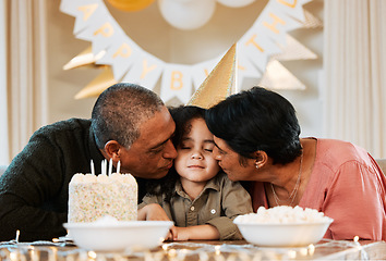 Image showing Birthday, cake and grandparents kiss child in living room for event, party celebration and social gathering. Happy, surprise and grandma, grandpa and kid with dessert, snacks and presents at home