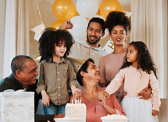 Image showing Birthday, party and family with cake for grandmother in living room for event, celebration and social gathering. Happy, surprise and grandparents, parents and kids with dessert, snacks and presents