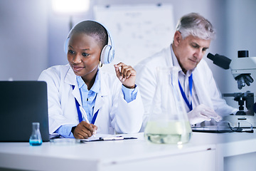 Image showing Science, laptop and people writing in a laboratory with internet, medical research or results. Man and black woman scientist or doctor with tech and headphones for scientific innovation or planning