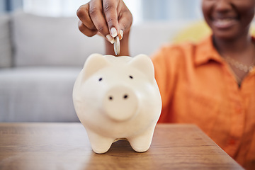 Image showing Woman, hands and coin in piggy bank for investment, finance or money savings on table at home. Hand of female person with piggybank for financial freedom, cash growth or budget planning in the house