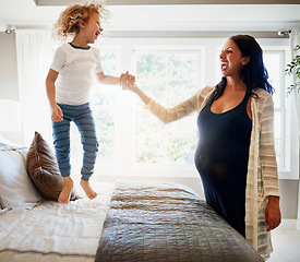 Image showing Happy family bedroom, pregnant woman and child jump, excited and have fun to celebrate baby maternity development. Happiness, energy or kid smile for life growth, pregnancy or expectation on home bed