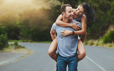 Image showing Love, piggyback or happy couple walking on road or outdoor date for care, support or loyalty. Freedom, romantic man or woman on holiday vacation together to relax or smile on street for wellness