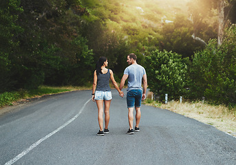 Image showing Road, travel or couple holding hands or walking on date with trust, care for romance, hiking or adventure. Loyalty, love or man with woman on holiday vacation together for bond, support or wellness