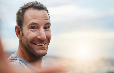 Image showing Portrait, smile or happy man in an outdoor selfie with confidence or freedom on holiday vacation. Face, sunrise space or person hiking in summer to travel or taking photograph or picture for memory