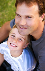 Image showing Portrait, happy man and son sitting on grass, cute bonding together with care and love from above. Fun, father and child on ground in backyard with smile, trust and support with parent and young boy.