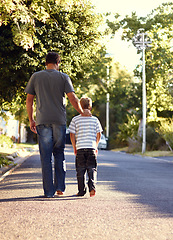 Image showing Back view, father and kid walking on street together for bonding, support and love on vacation or holiday in summer. Care, talking and dad on road with child in neighborhood on weekend as parent