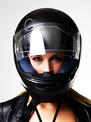 Image showing Motorbike helmet, portrait and sexy woman in studio isolated on white background. Biker, face and safety of serious girl, sports protection and fashion style, motorcyclist racer and beauty of driver