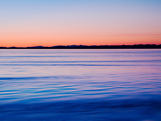 Image showing Sunset on horizon, water and lake outdoor, sky and mockup space in Mediterranean coastline reflection. Sea, ocean and sunrise at seascape at dawn in the morning in nature, calm scenery and summer