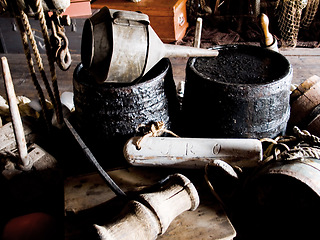 Image showing Interior, cabin and vintage tools, equipment and relics, barrels and bellows for storage of gear. Retro room, rustic cottage and old rope, wood and hammer in house, home and architecture in shack