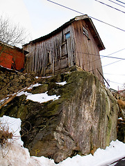 Image showing Wooden, house and snow on a cliff in Norway in winter weather for housing and living. Snowing, frozen and wood cabin outdoors in a village in the Scandinavian or Europe countryside for lifestyle