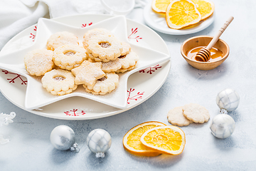 Image showing Homemade Christmas cookies with orange and honey.  Christmas decoration with ornaments.