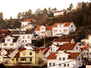 Image showing Facade, houses and village in Norway, Europe or tourism, travel or vacation. Exterior, wood home or Scandinavian buildings outdoor, vintage architecture or traditional landscape in retro neighborhood