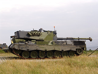 Image showing Military, nature and soldier transportation on field for warzone with a missile weapon in camouflage. Vehicle, landscape and army patrol service with gun for outdoor battle with conflict on land.